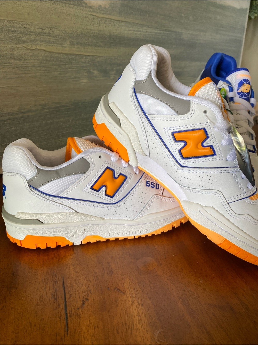 New Balance Kids 5.5/ Women’s 7.  White Sneakers with Orange & Blue Accent